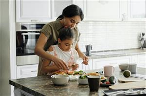 Mom and daughter cooking in kitchen