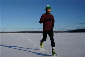 A man jogging in a wintery scene